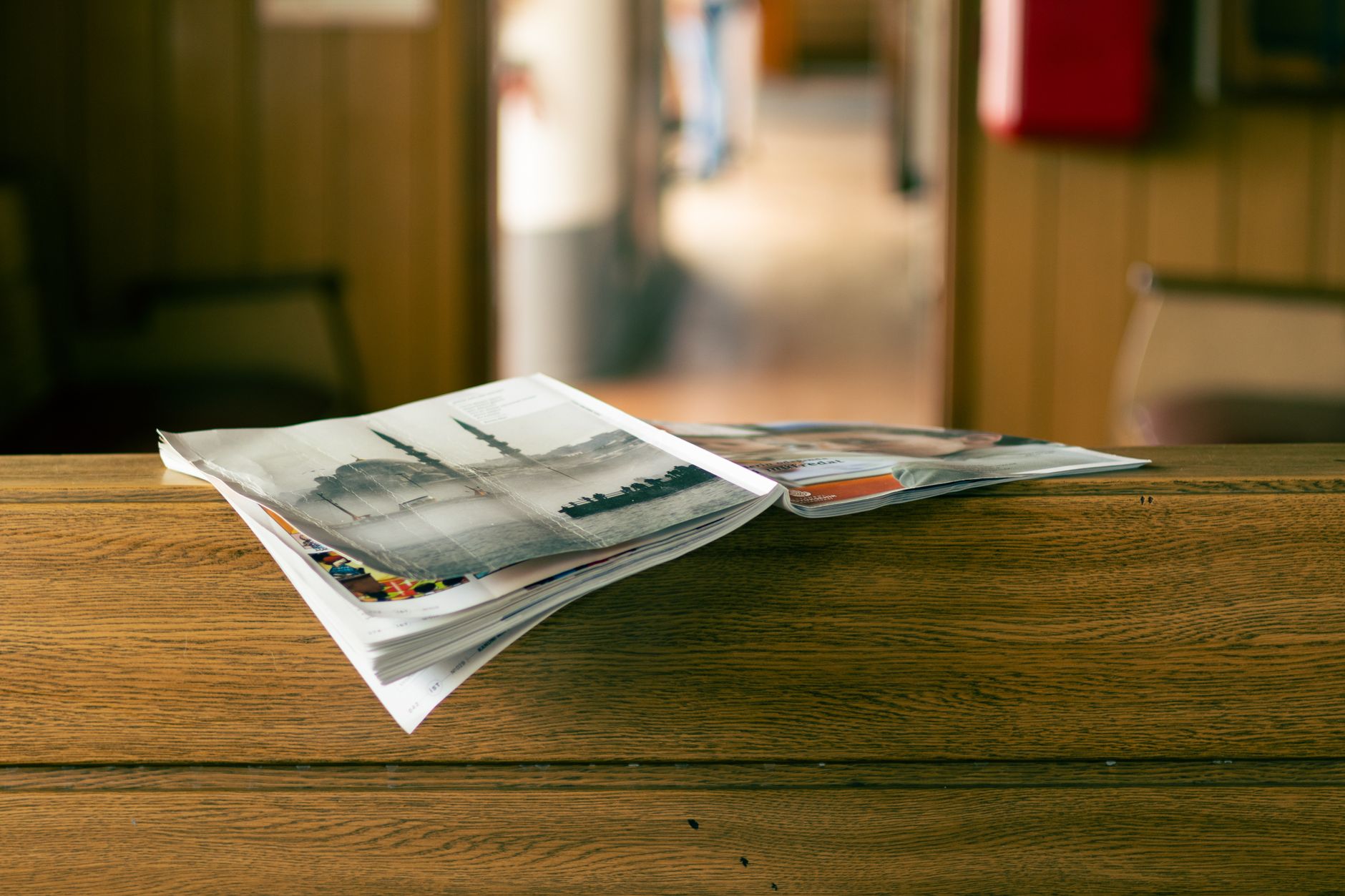 magazines on wooden table in cozy setting